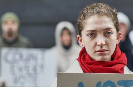 woman in red scarf at protest