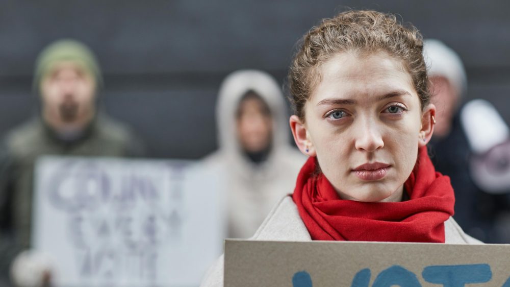 woman in red scarf at protest