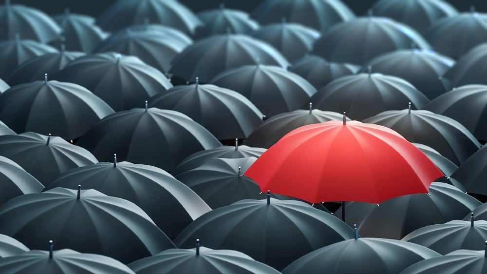 Red Colored Umbrella Between The Black Umbrellas