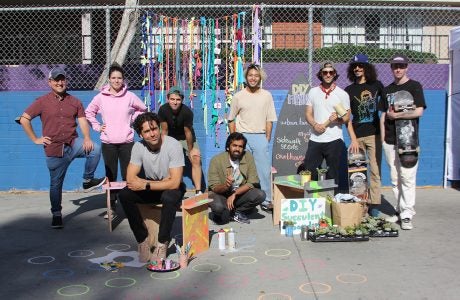 about 10 people who served as organizers and participants pose with amenities from the event|image shows event organizers facing camera|||