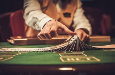 Croupier behind gambling table in a casino.