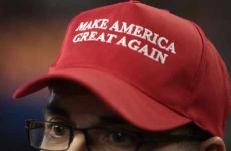 Close-up image of a man wearing a red "Make America Great Again" hat.