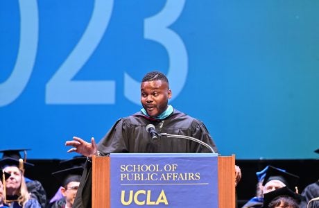 man in academic regalia at podium