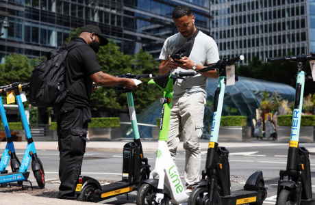 two men near electric scooters for rent