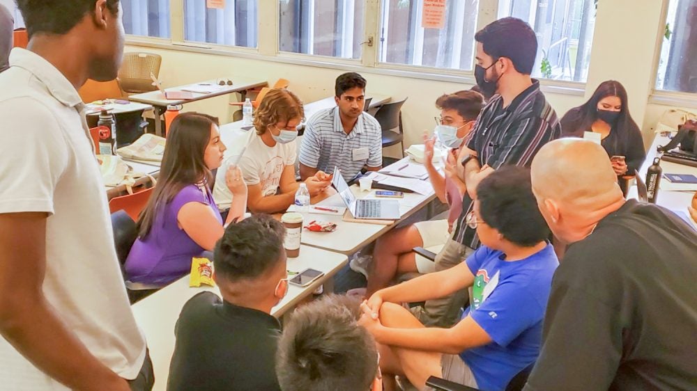young people huddle in discussion